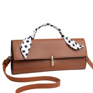 Brown faux leather crossbody bag with polka dot scarf handle and golden clasp