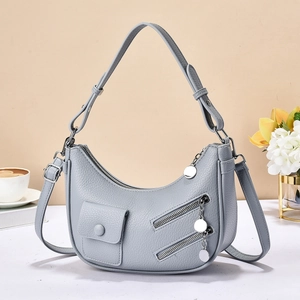 Chic light grey crescent leather handbag with lychee pattern and adjustable strap