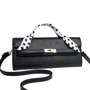 Classic black litchi grain leather handbag with gold clasp and polka dot scarf detail