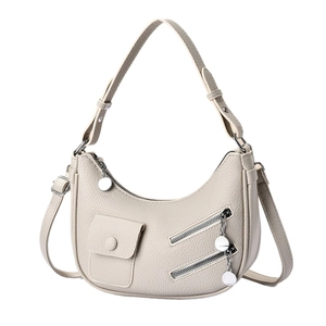 Minimalist beige moon-shaped leather shoulder bag with dual zipper and adjustable strap