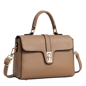 Brown lychee leather handbag with golden twist lock and top handle in minimalist style