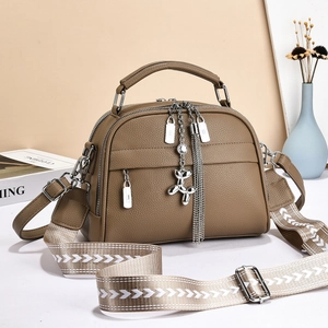 Brown lychee leather handbag with embroidered shoulder strap and balloon dog charm