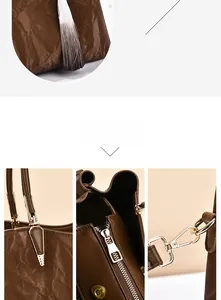 Detail of dark brown wrinkled leather bag with gold hardware and tassel pendant