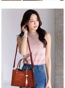Reddish brown textured handbag with tassel charm shown on model for a chic street style look