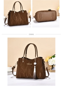 Detail view of brown pleated handbag with flower tassel and detachable shoulder strap
