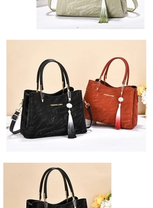 Detail of wrinkled texture and tassel charm on stylish soft leather women handbags