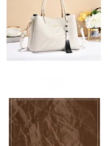 Close-up of marble pattern handbag with golden hardware and leather texture details