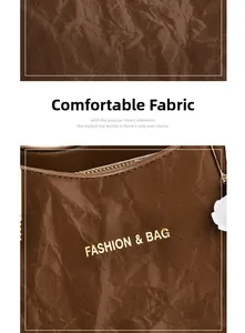 Close-up of brown textured leather wedding bag with fashion & bag logo and flower charm