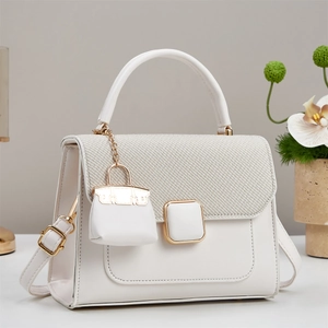 Elegant white crossbody bag with woven flap detail and gold buckle for women
