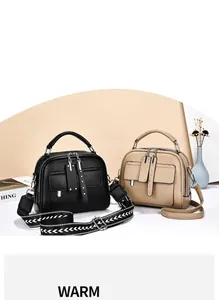 Detail of black and khaki textured leather handbags with stylish interchangeable straps