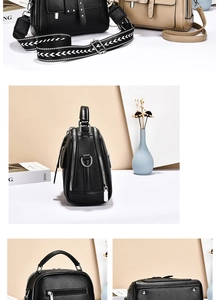 Detail of lychee pattern leather handbag with wide geometric strap and triple compartments