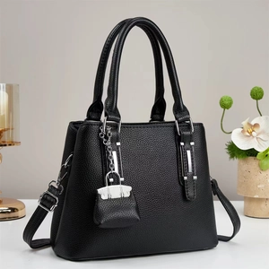 Minimalist black litchi pattern leather tote bag with silver hardware and long strap