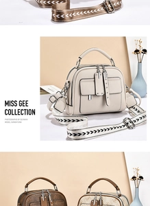 Detail of a chic leather shell bag with vintage pattern and stylish geometric wide strap