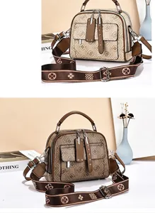 Detail of vintage monogram patterns on a large capacity shoulder bag with silver hardware