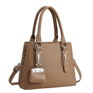 Brown lychee pattern leather tote bag with double handles and detachable strap on white background