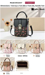 Detailed view of cherry print mini crossbody bag with metal chain strap and lock