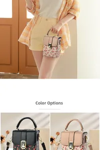 Detail view of cherry print mini crossbody bags in black and beige with gold twist locks