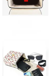 Detail of white cherry print handbag showing large capacity and multi-compartment interior