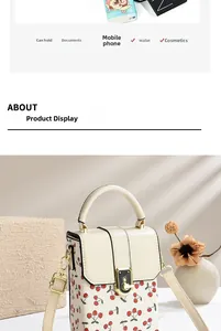 Detail of cream crossbody bag with cherry prints, gold twist lock and interior capacity view
