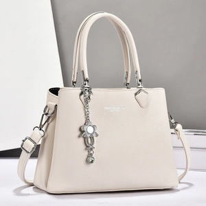 Elegant beige lychee grain leather tote bag with silver chain flower pendant and handles
