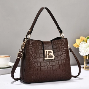 Deep brown crocodile embossed PU leather bucket bag with gold B buckle and crossbody strap
