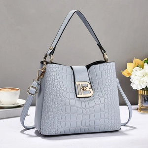 Light blue crocodile pattern bucket bag with gold B buckle and adjustable strap