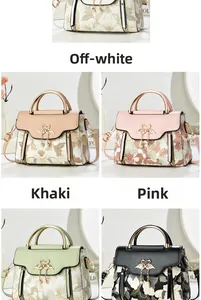 Detail of floral embroidery on handbags with swan buckle and metal ring handle