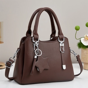 Elegant dark brown pebble leather tote bag with star pendant and adjustable strap