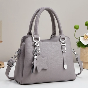 Minimalist grey textured leather handbag with detachable strap and star charm accessory