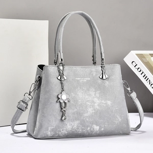 Elegant grey textured women's tote bag with metal flower charm and adjustable strap
