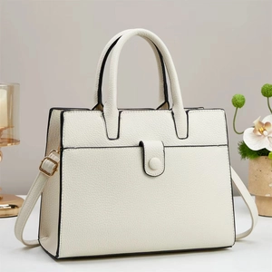White pebbled leather bucket bag with top handles and black edge paint detail