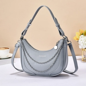 Close-up of grey hobo bag showing lychee grain texture and silver metal chain detail