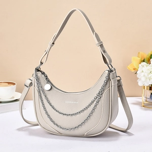 Beige crescent saddle bag with double silver chains and lychee grain leather texture