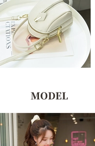 Detail of off-white lychee grain leather mini bag featuring high-quality gold metal zippers