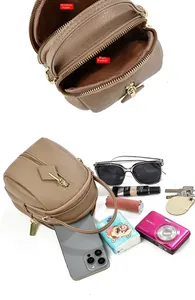 Detail of lychee pattern leather mini bag showing main and side zipper compartments storage