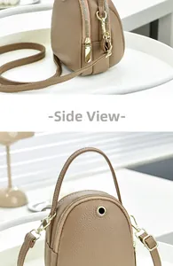 Side view detail of khaki cross-body bag featuring lychee texture and dual zippers