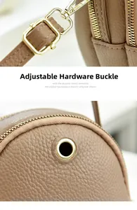 Detail of premium brown lychee leather and gold metal hardware clasp for small handbag