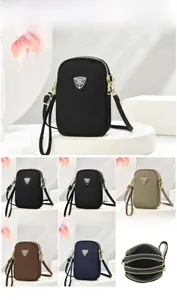 Three-layer zipper nylon crossbody bag showing detailed internal storage and structure
