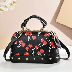 Vintage doctor bag with red cherry prints and golden rivets on black leather base