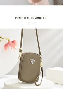 Detail view of khaki three-layer crossbody phone bag with durable zippers and textures