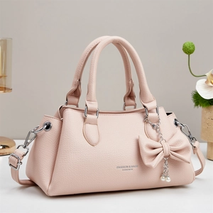 Pink lychee grain leather handbag with top handles and a detachable crossbody strap