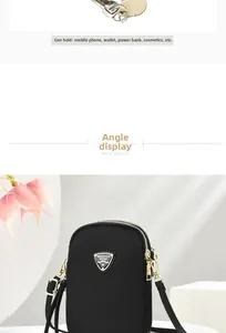 Detail of black mini crossbody bag with double gold zippers and metal shield logo