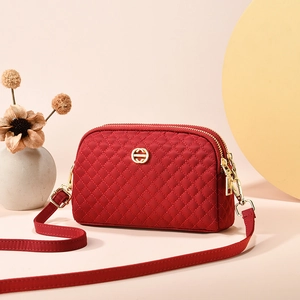 Petit sac bandoulière rouge matelassé avec double fermeture éclair et logo doré