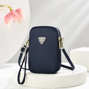 Navy blue small crossbody bag for women with golden logo and multiple zippers