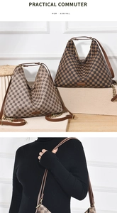 Close-up of checkerboard patterned shoulder bag featuring chain strap and brand plate