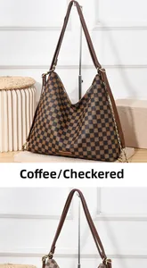 Detail of coffee brown checkered hobo bag with leather strap and gold chain accent