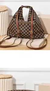 Detail view of the brown checkered canvas handbag back with gold hardware and zipper pocket