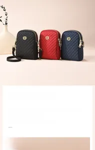Detail view of small quilted oxford bags in black, burgundy, and navy with dual zippers