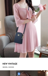 Quilted navy blue oxford bag with golden logo worn by model in pink dress