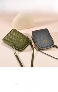 Detail of dual zipper compartments and quilted pattern on nylon crossbody bags
